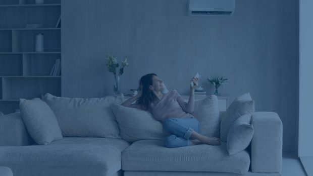 relaxed-young-hispanic-female-homeowner-sitting-huge-comfortable-couch-turning-air-conditioner-with-remote-controller-switching-cooler-system-setting-comfortable-temperature-living-room (1)